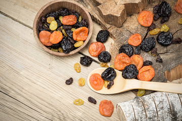 Still life with dried fruits and wooden trimming