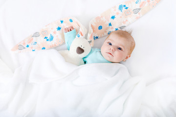 Adorable cute newborn baby girl with Easter bunny toy