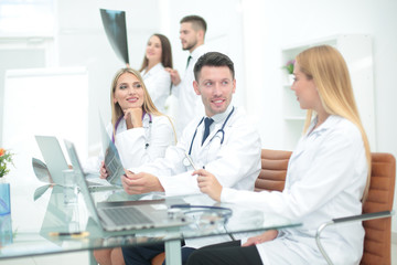 Fototapeta premium Smiling doctors working at office desk and smiling, medical office