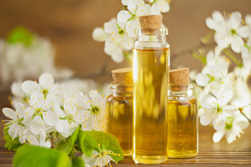 Essence of flowers on table in beautiful glass jar