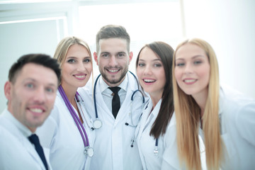 Smiling team of doctors at hospital making selfie.