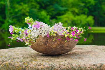Summer wild flowers in a big wooden pot