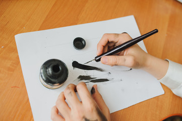 Female hand artist paint with ink a new picture
