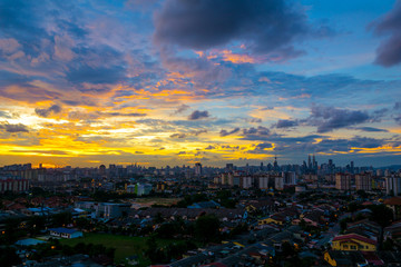Fototapeta na wymiar A cloudy sunset in Kuala Lumpur, the capital of Malaysia. Its modern skyline is dominated by the 451m tall KLCC, a pair of glass and steel clad skyscrapers.