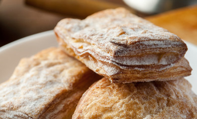 Puff pastry cookie with powdered sugar macro shot