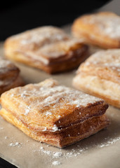 Puff pastry with powdered sugar closeup shot, vertical