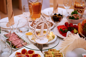 Served food and decorated the wedding table. With a sign from wood ,painted white No. 1