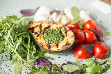 Italian breakfast with avocado, mozzarella, tomatoes and pesto sauce