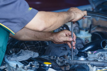 Engine repair,Mechanic working in a car under the hood,Engine repair service station.