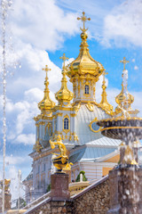 Fountain and church of the palace of Peterhof. St Petersburg, Russia