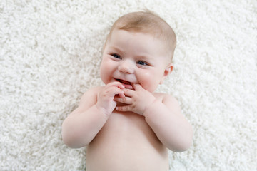 Adorable naked baby girl on white background. © Irina Schmidt