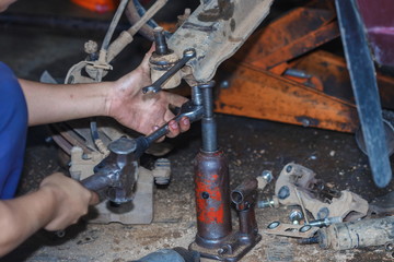 Engine repair,Mechanic working in a car under the hood,Engine repair service station.