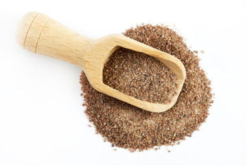 Himalayan black salt (Kala namak) with wooden scoop isolated on white background. Top view