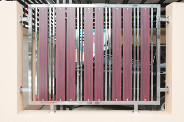 Wrought stainless steel and wood fence