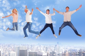 Fototapeta na wymiar Composite image of men and women jumping against white backgroun