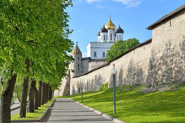 View of Trinity Cathedral and Dovmontova the tower to the walkway on the embankment of the Velikaya river