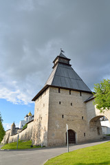 Fortress tower in the alley on the embankment of the river Great