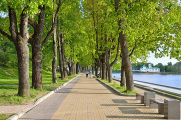 A couple of passersby on the walk of the embankment of the river great