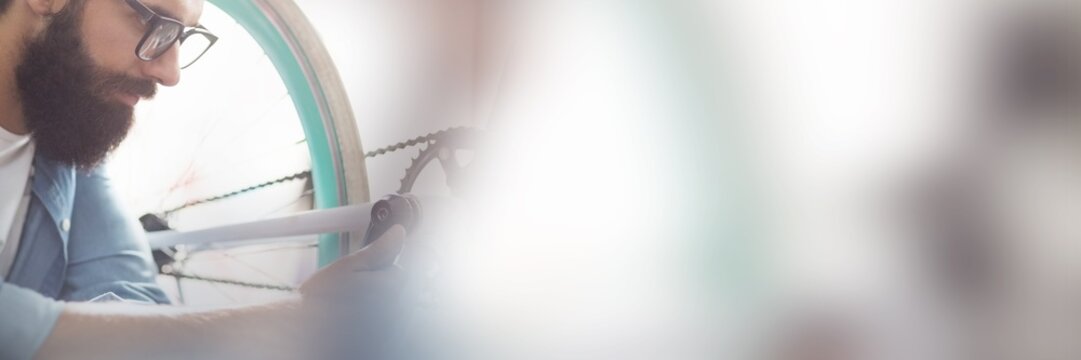 Side view of mechanic checking bicycle