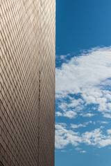 Fototapeta na wymiar Abstract tiled wall next to blue sky