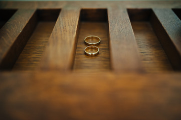 wedding rings on wooden background