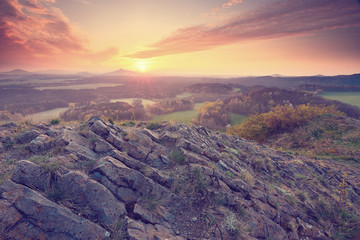 Misty valley, sharp rocks gentle cut creamy fog to strips. Long deep valley full of fresh spring mis © rdonar