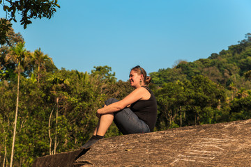Young woman is exercising in the mountains.
