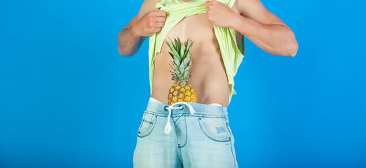 Pineapple. Portrait of funny man with great pineapple. Fruits. Summer time. Summer concept. Fashion. Sexy couple. Love fruits. Sexy man body. Denim jeans. Erotic game. Hot guy. Beauty photo. Sensual
