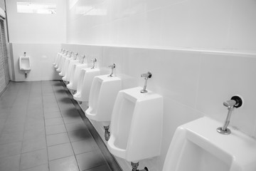 clean urinals men in toilet