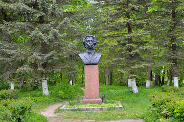 Bust monument to A. S. Pushkin among the firs