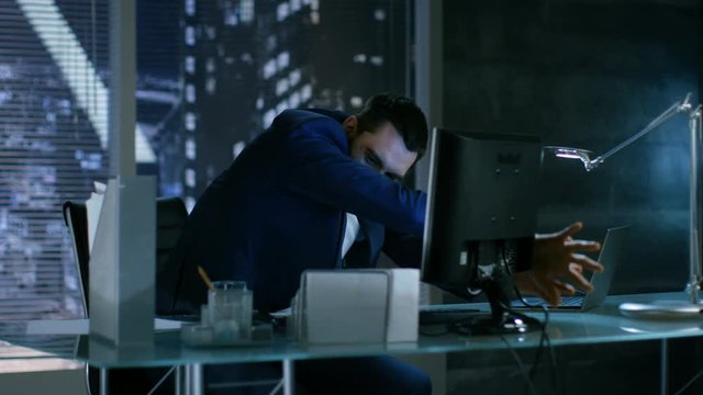 Late at Night Businessman Looses Temper Throws Everything Of His Table. He Works in a Private Office with Big City Window View. Shot on RED EPIC-W 8K Helium Cinema Camera.
