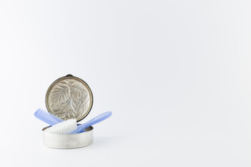 Baby boy luxurious items collection isolated on white background.  A blue hairbrush and comb in an ornament silver box.