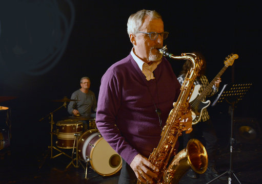 Male playing sax with eyes closed