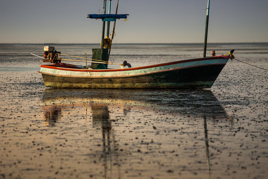Fishing boat on the ground at low tide.