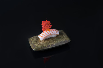 Salmon sushi nigiri isolated on black background
