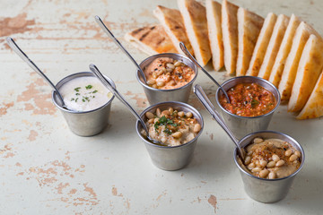 Set of appetizers: hummus, muhammara, tirokafteri, Greek cacik