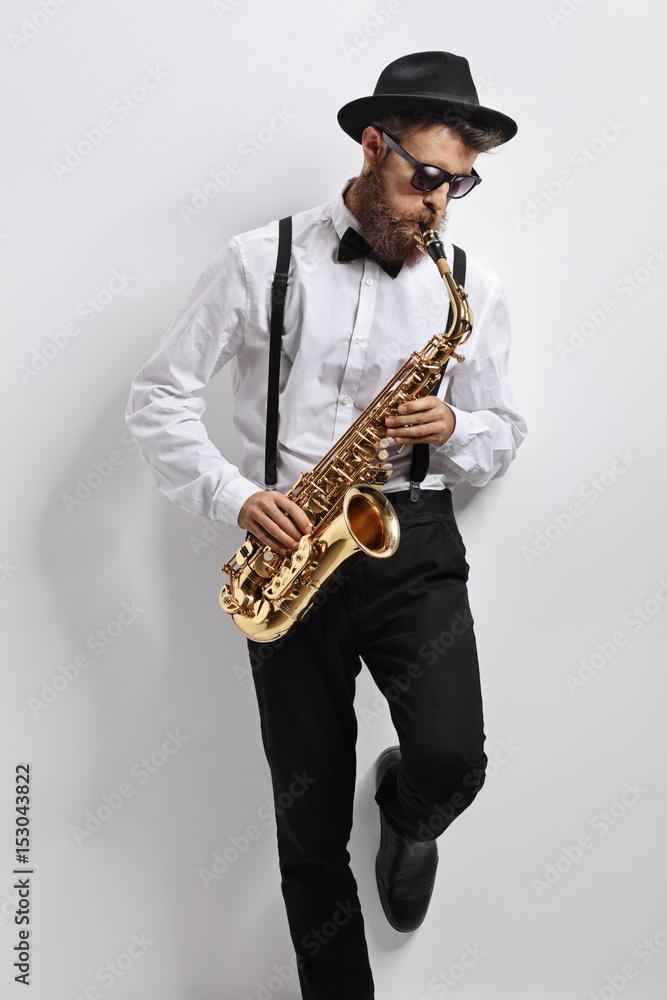 Sticker jazz musician leaning against a wall and playing saxophone