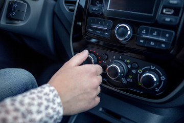 Male hand pressing button in modern car