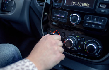 Fototapeta premium Male hand pressing button in modern car