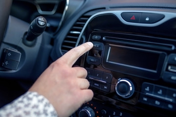 Fototapeta premium A man Pressing Button On Dashboard While Driving Car