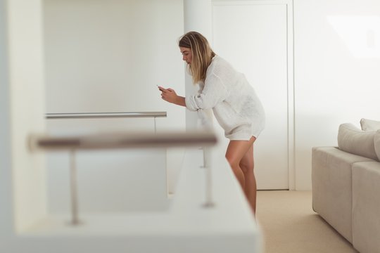 Woman Using Mobile Phone At Home