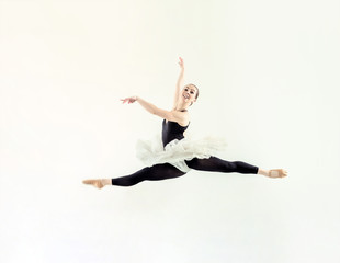 Elegant ballerina jump in ballet hall