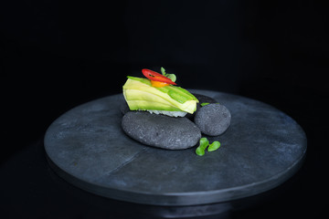 vegan nigiri with avocado on grey stone