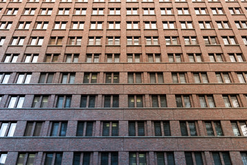 Fototapeta premium high rise brick building facade - window pattern