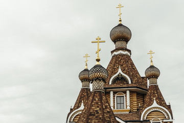 Fototapeta na wymiar Domes and crosses of a wooden orthodox church 