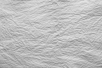 White crumpled sheet of paper. Grungy background texture with copy space for text or image.