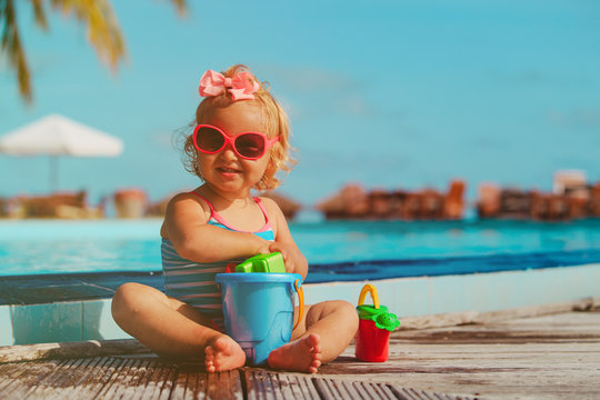 cute little girl playing on tropical beach