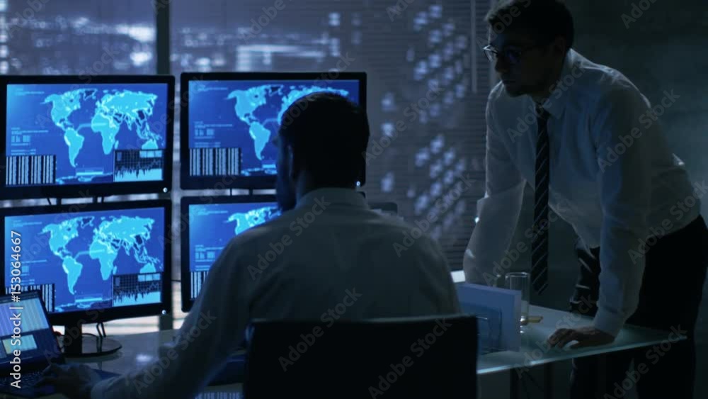 Poster Late at Night in Office Building Security Service Men Have Discussion while  Attentively Observing Monitors with Location Sensitive Information Shown on Them.  Shot on RED EPIC-W 8K Helium Camera