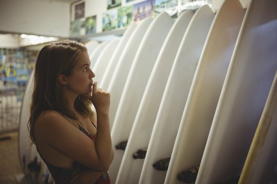 Woman selecting a surfboard