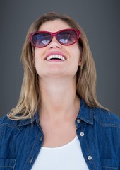 Woman in sunglasses against grey background